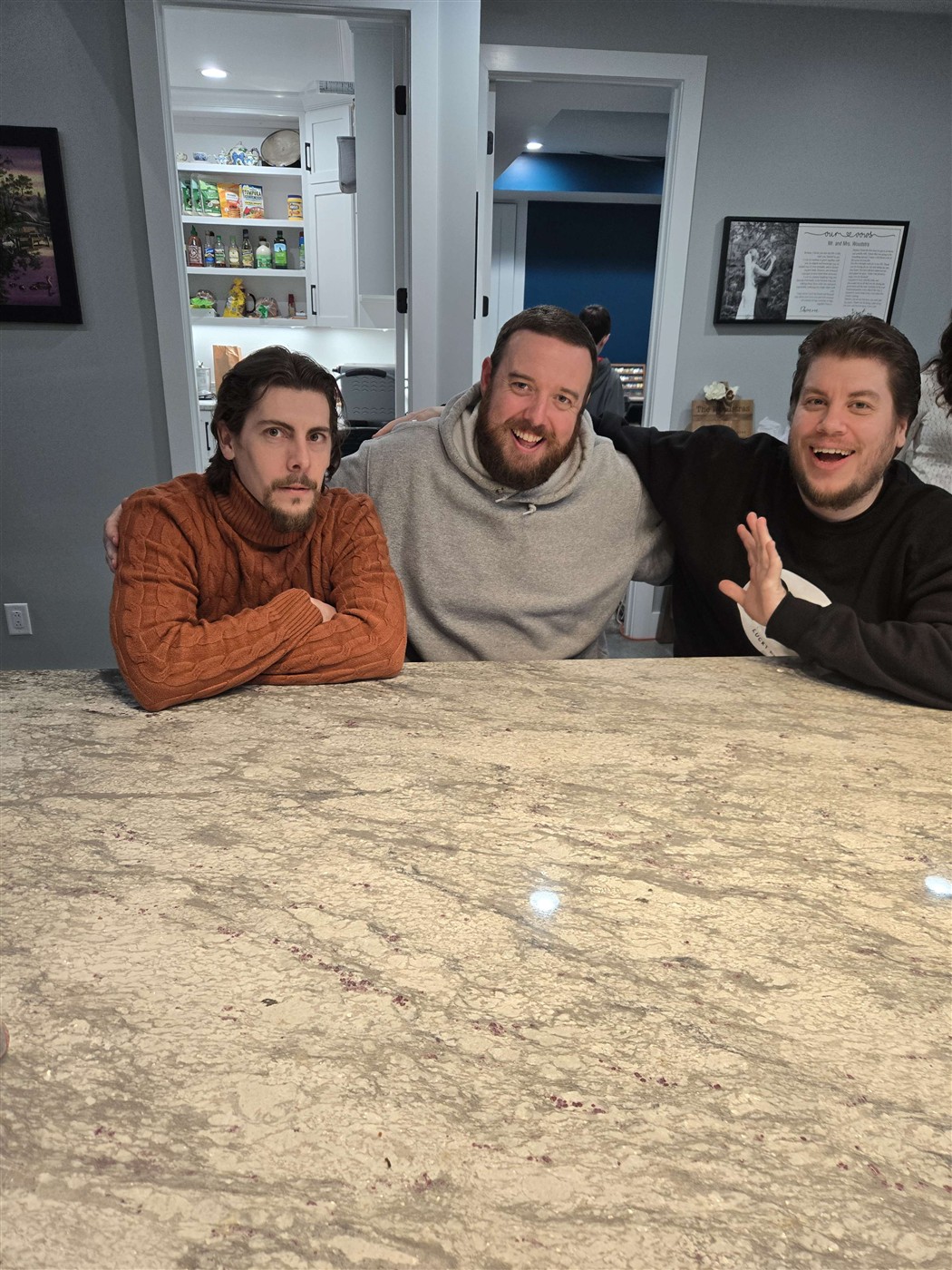 JT and friends gathered at a kitchen counter